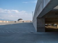 several large empty parking spaces in the city with buildings nearby in front of them -