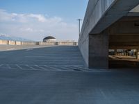 several large empty parking spaces in the city with buildings nearby in front of them -