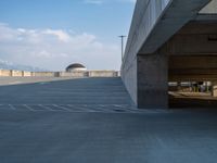 several large empty parking spaces in the city with buildings nearby in front of them -