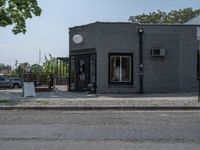 a store on the corner in a small town that has lots of gray brick walls