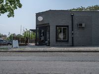 a store on the corner in a small town that has lots of gray brick walls