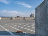 several large empty parking spaces in the city with buildings nearby in front of them -