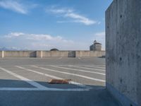 several large empty parking spaces in the city with buildings nearby in front of them -