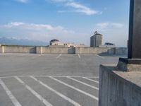 several large empty parking spaces in the city with buildings nearby in front of them -