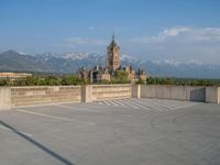 several large empty parking spaces in the city with buildings nearby in front of them -