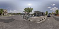 a 360 - angle shot shows the intersection of a small town street and some parking meters