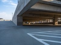 several large empty parking spaces in the city with buildings nearby in front of them -