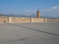 several large empty parking spaces in the city with buildings nearby in front of them -