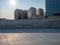 several large empty parking spaces in the city with buildings nearby in front of them -