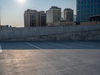 several large empty parking spaces in the city with buildings nearby in front of them -