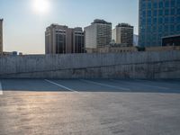 several large empty parking spaces in the city with buildings nearby in front of them -