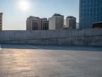 several large empty parking spaces in the city with buildings nearby in front of them -