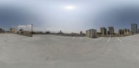 this is a 360 - shot of a city and the sky in the background with clouds