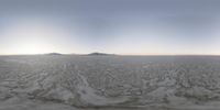 a 360 - angle photo of the snow - covered ground surrounding a city with mountains in the background