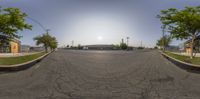 the sun shines through a cloudless sky over a street in an industrial setting