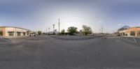 an empty street is pictured through the distorted lens of a panoramic photo taken