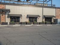 the empty street outside of the business district is empty and deserted with vehicles parked in it