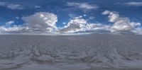 a view looking through a hole in a sky with clouds above the sky and below