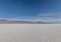 a view of the barren and barren desert with the mountains in the background on a clear day