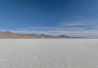 a view of the barren and barren desert with the mountains in the background on a clear day