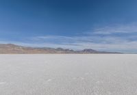 a view of the barren and barren desert with the mountains in the background on a clear day