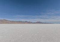 a view of the barren and barren desert with the mountains in the background on a clear day