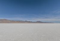 a view of the barren and barren desert with the mountains in the background on a clear day