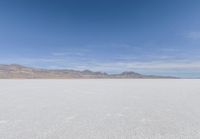 a view of the barren and barren desert with the mountains in the background on a clear day