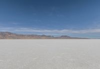 a view of the barren and barren desert with the mountains in the background on a clear day