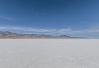 a view of the barren and barren desert with the mountains in the background on a clear day