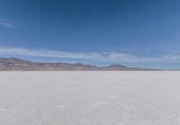 a view of the barren and barren desert with the mountains in the background on a clear day