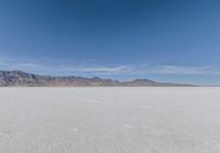 a view of the barren and barren desert with the mountains in the background on a clear day