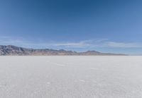 a view of the barren and barren desert with the mountains in the background on a clear day