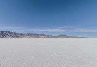 a view of the barren and barren desert with the mountains in the background on a clear day