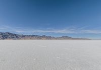 a view of the barren and barren desert with the mountains in the background on a clear day