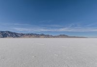 a view of the barren and barren desert with the mountains in the background on a clear day