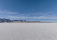 a view of the barren and barren desert with the mountains in the background on a clear day