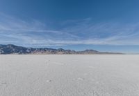 a view of the barren and barren desert with the mountains in the background on a clear day