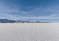 a view of the barren and barren desert with the mountains in the background on a clear day