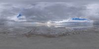 a picture of the ocean and sky taken through a lens with reflection on the water