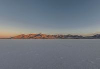 the vast plain is empty and no clouds or cloudless as the sun sets on it