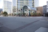 the street is empty, surrounded by many tall buildings that make up the city center