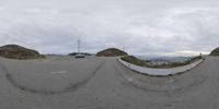 a man riding his skateboard down a hill above a hillside covered in cars and houses