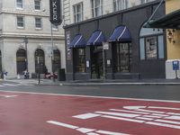 the stoplight near the store is red painted on the street road next to the sign for the shop