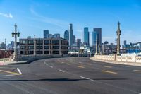 a street light on a bridge next to buildings and road sign in the city of san francisco