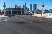 a street light on a bridge next to buildings and road sign in the city of san francisco