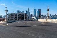 a street light on a bridge next to buildings and road sign in the city of san francisco