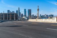 a street light on a bridge next to buildings and road sign in the city of san francisco