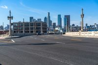 a street light on a bridge next to buildings and road sign in the city of san francisco