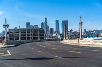 a street light on a bridge next to buildings and road sign in the city of san francisco